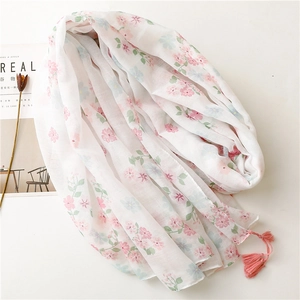 Elegant white floral scarf with pink tassels made of breathable linen-feel fabric