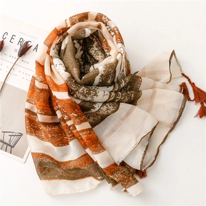 Detailed shot of bohemian striped scarf fabric with tassels and soft fabric texture