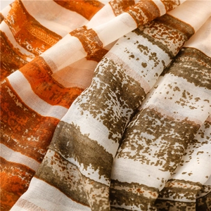 Detail view of bohemian striped scarf with soft texture and refined fringe finish