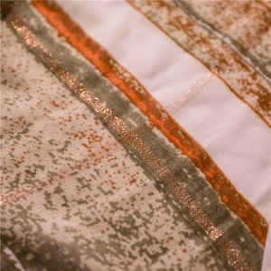 Detail of bohemian scarf fabric with colored stripes and sparkling gold glitter texture