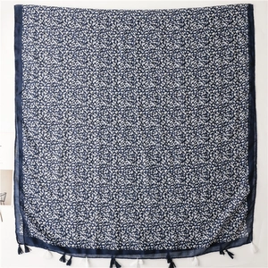Dettaglio della sciarpa bohémien blu navy con motivi a foglia e frange eleganti