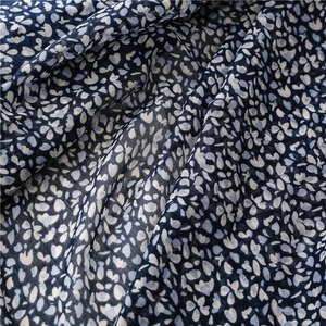 Vista dettagliata del tessuto bohémien blu navy con morbida trama floreale stampata
