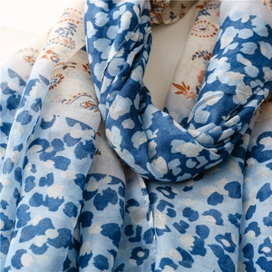 Detail of bohemian blue and white paisley scarf with floral and geometric print texture