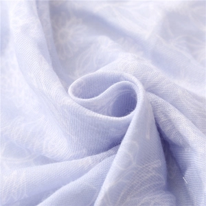 Macro detail of light purple floral linen feel fabric with soft texture and white flower prints