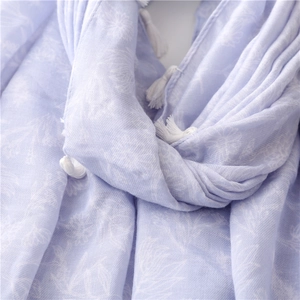 Detail of light purple floral shawl featuring soft texture and white tassel fringes