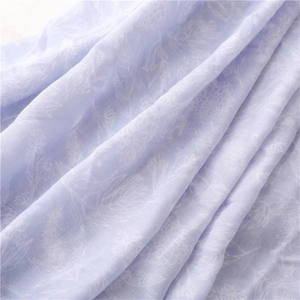 Detailed texture of light purple floral beach shawl with soft cotton linen feel fabric