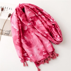 Detail of pink tie-dye shawl with tassels and lightweight fabric for summer beach wear