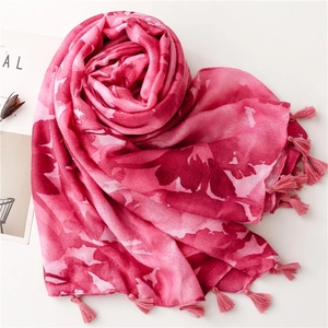 Detailed macro view of soft pink bohemian floral scarf with delicate fringed edges and soft texture