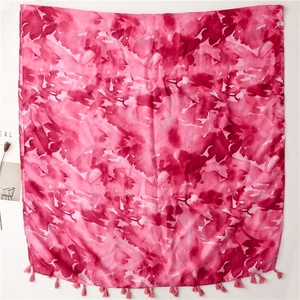 Detail of pink watercolor artistic print shawl with delicate tassel edge decoration