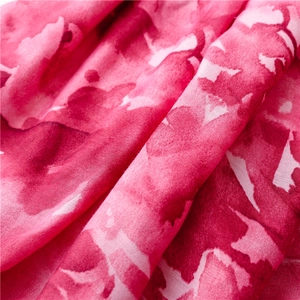 Detailed macro view of bohemian ink painting pattern on soft rose red sun-shielding shawl