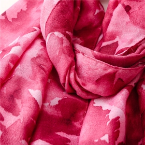 Macro detail of breathable pink boho watercolor print fabric for summer sun shawls