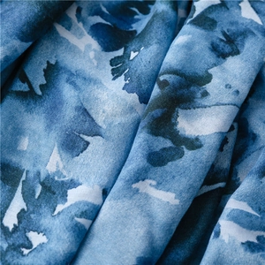 Detail of blue abstract floral print fabric with soft watercolor ink texture on beach shawl