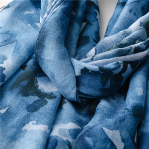 Close-up of blue watercolor ink pattern on lightweight soft summer beach shawl fabric