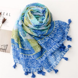 Detailed shot of Bohemian scarf with geometric patterns and deep blue tassel edges