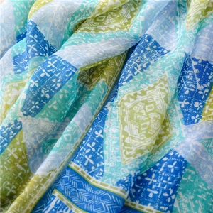 Close-up of bohemian shawl featuring geometric diamond patterns and soft linen texture