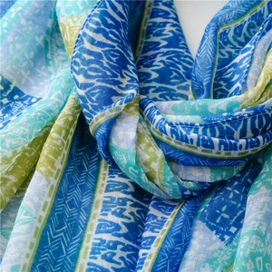 Detail of bohemian geometric pattern shawl in blue and green with soft cotton texture
