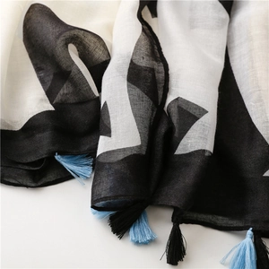 Detailed view of lightweight cotton scarf with geometric patterns and fringe edges