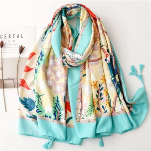 Floral print beach shawl with turquoise and yellow patterns and fringe tassels