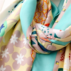 Detailed macro view of floral silk scarf texture with soft blue and orange patterns