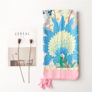 Detail of floral silk shawl with blue flowers, pink tassel fringe and letter L pattern