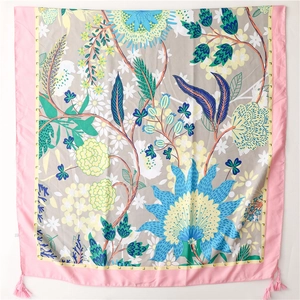 Detailed view of floral silk shawl with pink tassels and elegant grey flower pattern