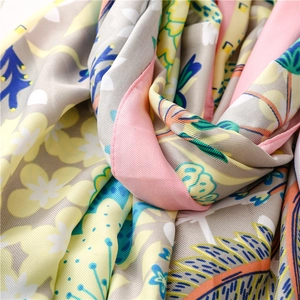 Macro view of floral silk scarf fabric texture with rolled edges and vibrant prints
