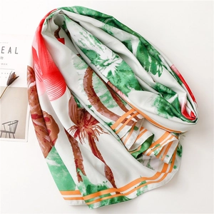 Detail of summer scarf showing tropical green palm leaf print and striped silk edges