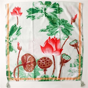 Detail of silk scarf showing red lotus flowers, green lotus pods and fringe tassels