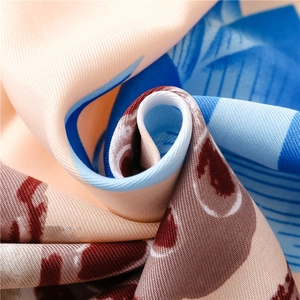 Close-up of beach shawl showing premium twill weave with blue stripes and floral patterns