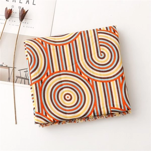 Detailed view of colorful geometric rainbow scarf with soft fringe edges and concentric circles