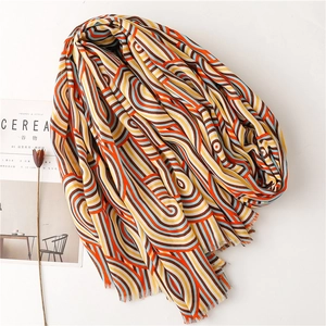 Rainbow wave pattern scarf with soft cotton texture and fringed edges in warm tones
