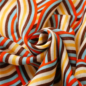 Detailed macro view of vibrant rainbow wave patterns on soft cotton linen fabric