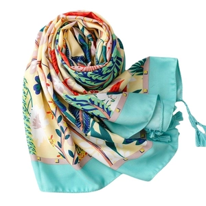Floral silk shawl with tropical leaves and tassels in yellow and green for summer beach sun protection