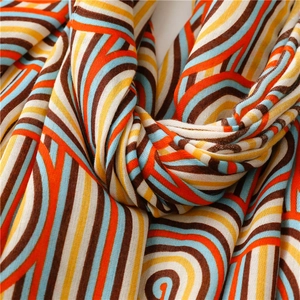 Close-up of soft multi-colored rainbow striped cotton scarf with woven texture details