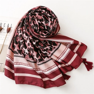 Detail of leopard print and geometric stripes silk scarf with fringed edges