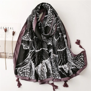 Elegant black silk scarf with white abstract vein patterns and delicate tassels