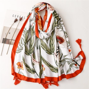 Lightweight floral beach shawl with orange tassels and green leaves print for summer sun protection