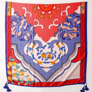 Detail of ethnic silk scarf featuring auspicious cloud patterns and blue tassels