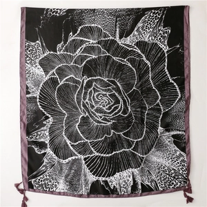 Detail of floral and leopard print silk scarf with purple trim and elegant tassels