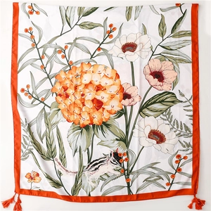 Detail of floral silk scarf with orange tassels featuring squirrels and hydrangeas