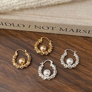 Luxe pearl drop earrings set in gold and silver finish with textured geometric hoop detail