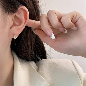 Elegant gold-plated tassel earrings with zircon studs shown on a female model