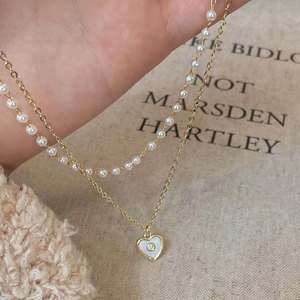 Double-layered heart shell pendant necklace with white pearls and gold-plated chain
