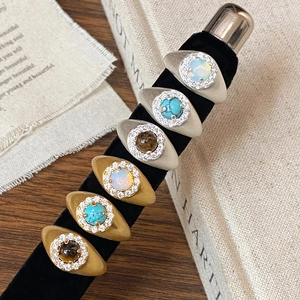 Vintage gold and silver rings with natural stones and zircon on black velvet