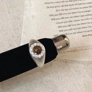 Macro view of vintage silver ring with brown tiger eye stone and zircon halo detailing