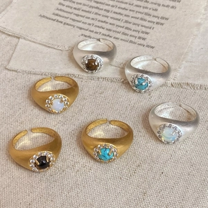 Detail of vintage adjustable rings with various gemstones and matte metallic textures