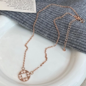 Detailed view of rose gold round geometric pendant with sparkling crystals and fine chain