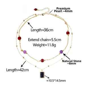Close-up of double-layer gold chain necklace with square black gemstone and colorful beads