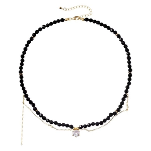 Elegant black beaded necklace with sparkling zircon pendant and gold accents on white base