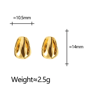 Detail view of gold-plated geometric oval studs with irregular concave surface texture